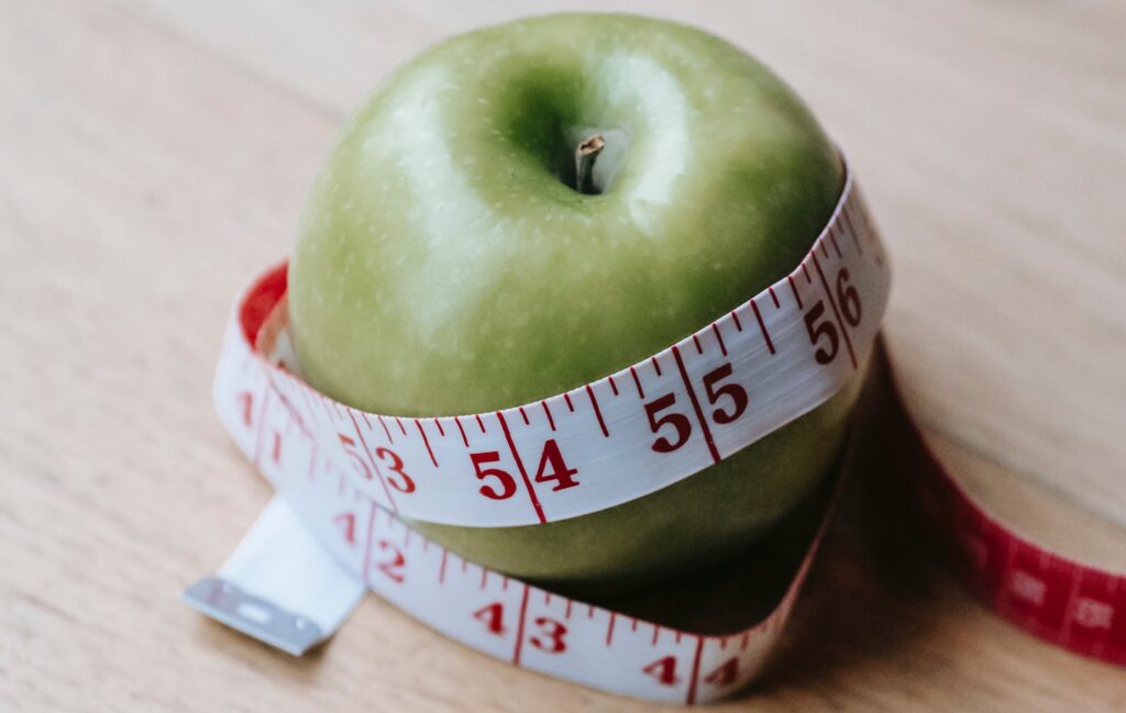 Measure tape around an apple